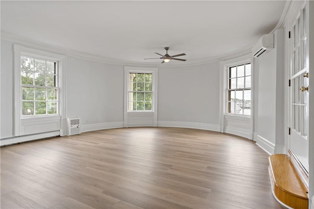 217 Hope St Unit 3, Bristol, RI 02809 - empty room with a ceiling fan, crown molding, a wall unit AC, wood finished floors, and baseboards