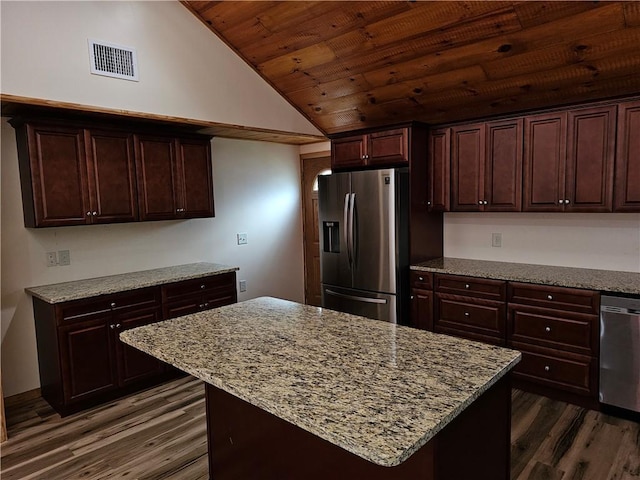 121 Friendship St, North Providence, RI 02904 - kitchen featuring stainless steel appliances, dark wood-type flooring, lofted ceiling, light stone countertops, and a kitchen island