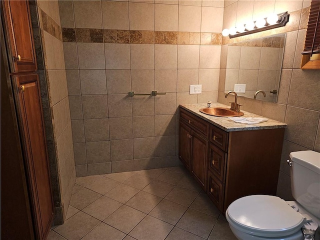 121 Friendship St, North Providence, RI 02904 - bathroom featuring tile walls, toilet, vanity, and tile patterned flooring