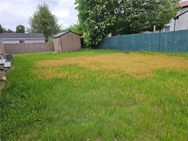 121 Friendship St, North Providence, RI 02904 - view of yard with fence, a storage unit, and an outdoor structure