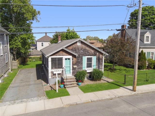 10 Curry Ave, Newport, RI 02840 - view of front of home featuring asphalt driveway, entry steps, and a chimney