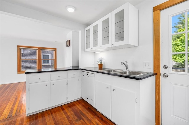 10 Curry Ave, Newport, RI 02840 - kitchen featuring white dishwasher, a sink, dark wood-type flooring, and a peninsula