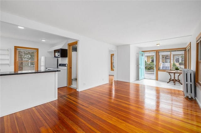 10 Curry Ave, Newport, RI 02840 - unfurnished living room with radiator, hardwood / wood-style flooring, and plenty of natural light