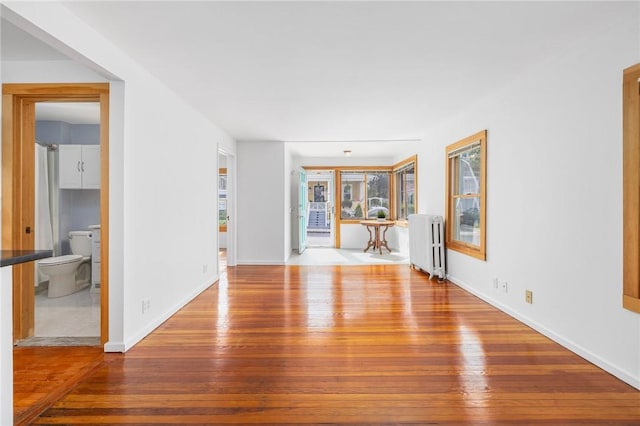 10 Curry Ave, Newport, RI 02840 - unfurnished living room with radiator heating unit, wood-type flooring, and baseboards