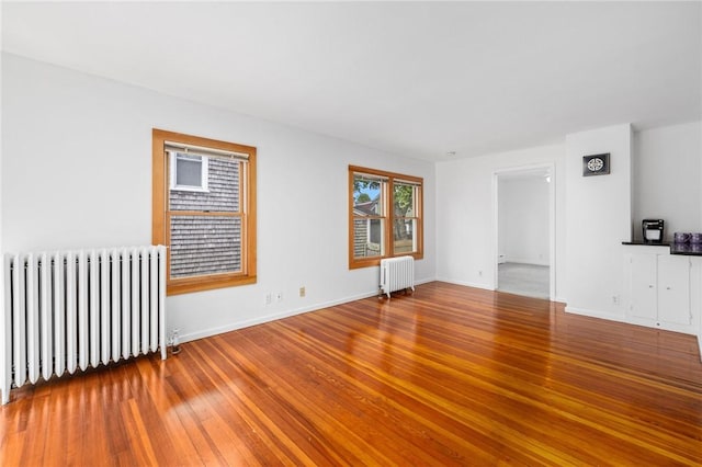 10 Curry Ave, Newport, RI 02840 - empty room featuring radiator, wood-type flooring, and baseboards