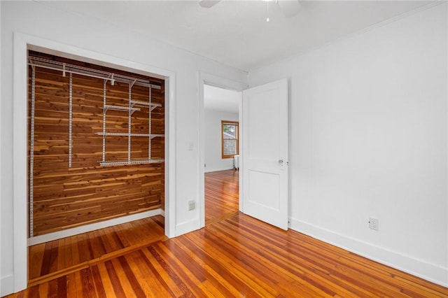 10 Curry Ave, Newport, RI 02840 - unfurnished bedroom with wood finished floors, baseboards, and a ceiling fan