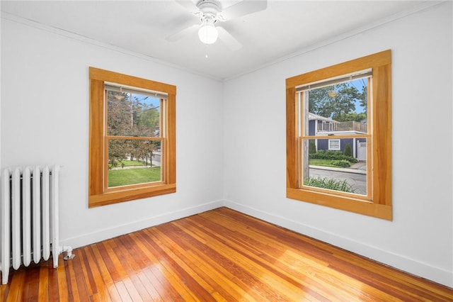 10 Curry Ave, Newport, RI 02840 - empty room with radiator heating unit, plenty of natural light, hardwood / wood-style floors, ornamental molding, and baseboards