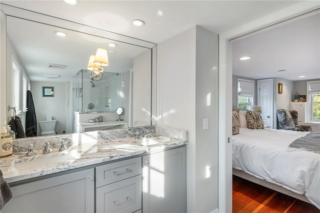 15 Rumstick Dr, Barrington, RI 02806 - full bathroom featuring ensuite bath, toilet, double vanity, wood finished floors, and a shower