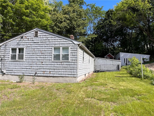 30 Japonica St, Pawtucket, RI 02860 - view of property exterior featuring a chimney, a lawn, and view of scattered trees