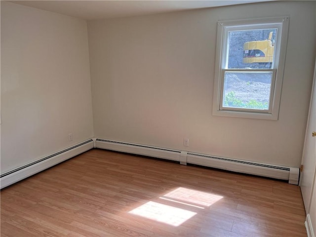30 Japonica St, Pawtucket, RI 02860 - empty room with light wood-type flooring, plenty of natural light, and a baseboard heating unit