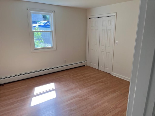30 Japonica St, Pawtucket, RI 02860 - unfurnished bedroom with a baseboard radiator, light wood-style flooring, a closet, and baseboards