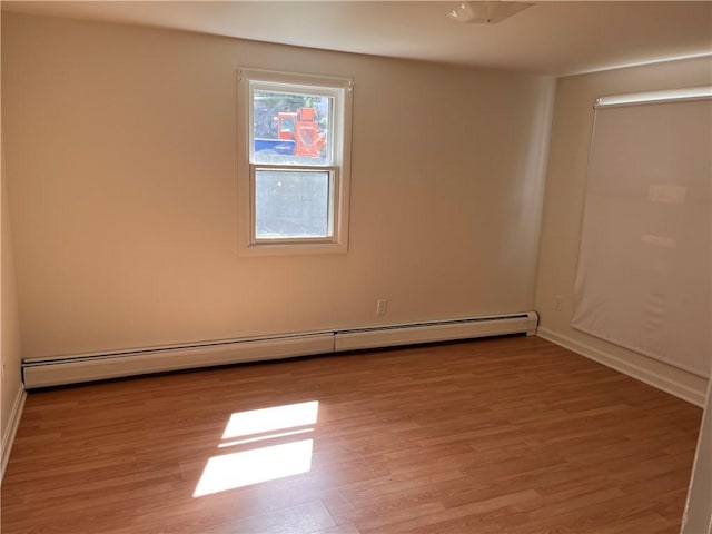 30 Japonica St, Pawtucket, RI 02860 - spare room with a baseboard heating unit, wood finished floors, and baseboards