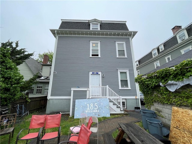 185 Williams St, Providence, RI 02906 - back of property with mansard roof, roof with shingles, and a patio