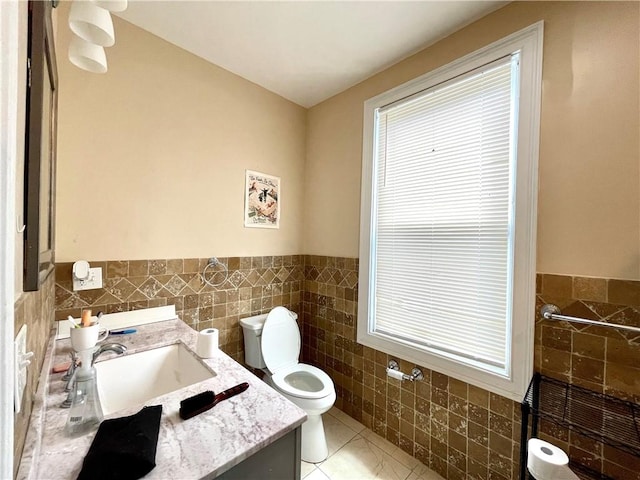 185 Williams St, Providence, RI 02906 - bathroom featuring tile walls, toilet, vanity, a wainscoted wall, and tile patterned flooring