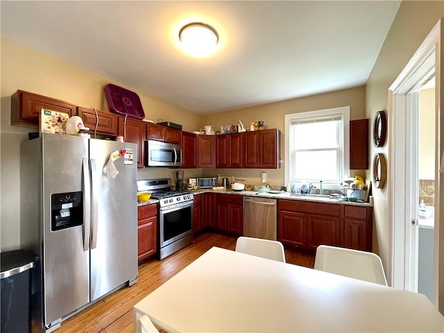 185 Williams St, Providence, RI 02906 - kitchen with appliances with stainless steel finishes, light wood-type flooring, a sink, and light countertops