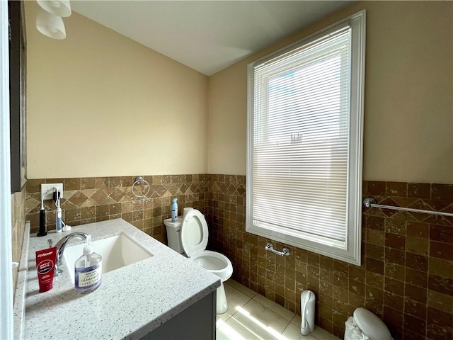 185 Williams St, Providence, RI 02906 - bathroom featuring tile walls, vanity, toilet, a wainscoted wall, and tile patterned floors