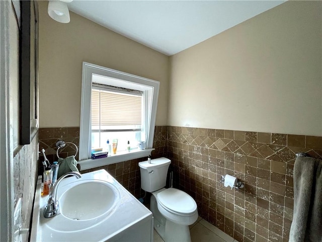 185 Williams St, Providence, RI 02906 - half bath featuring tile walls, toilet, a wainscoted wall, vanity, and tile patterned flooring