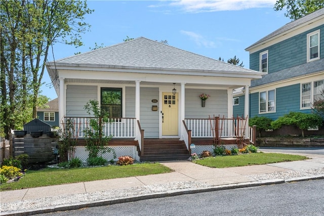 view of front of property with covered porch and roof with shingles