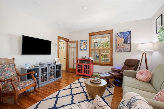 living area with wood finished floors and baseboard heating