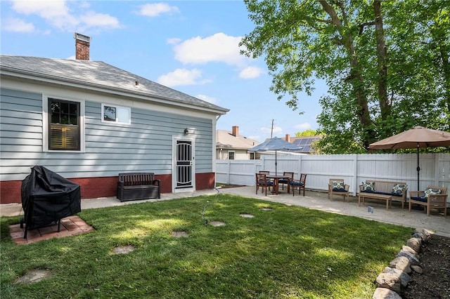 back of property with a patio and a chimney
