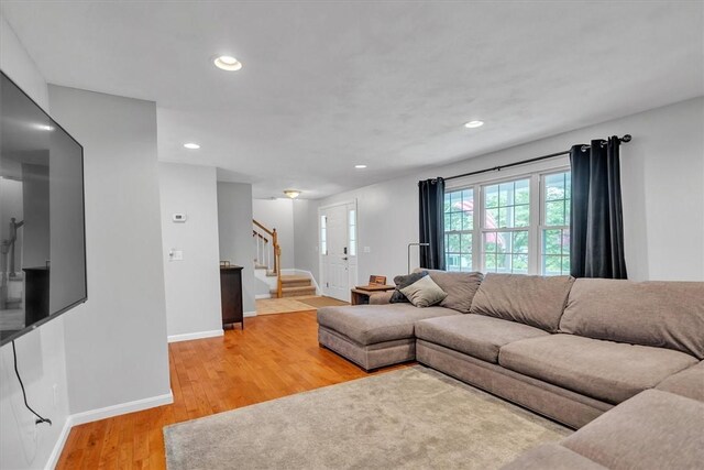 23 Blissdale Ave, Cumberland, RI 02864 - living room featuring stairway, light wood-style flooring, baseboards, and recessed lighting