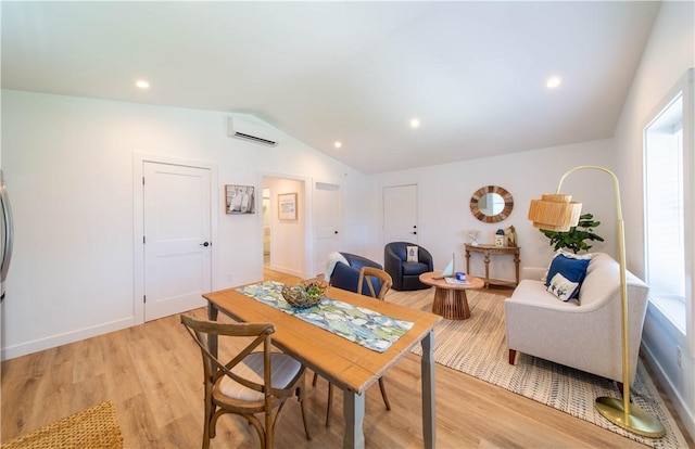 32 Exchange St Unit 101, East Greenwich, RI 02818 - dining room featuring vaulted ceiling, light wood-type flooring, a wall mounted AC, baseboards, and recessed lighting