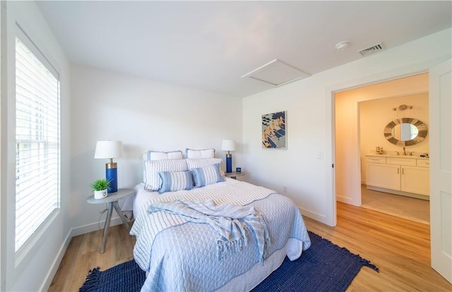 32 Exchange St Unit 101, East Greenwich, RI 02818 - bedroom with attic access, light wood-style floors, and baseboards