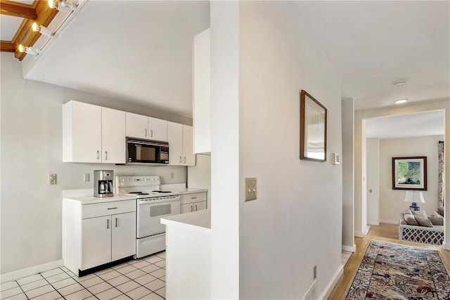15 Hammersmith Rd Unit 19, Newport, RI 02840 - kitchen with white electric range, black microwave, light countertops, baseboards, and white cabinetry