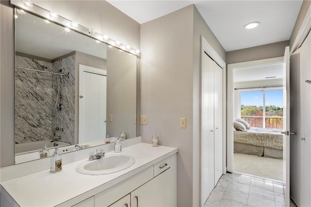 15 Hammersmith Rd Unit 19, Newport, RI 02840 - bathroom featuring marble look tiles, vanity, ensuite bathroom, and  shower combination