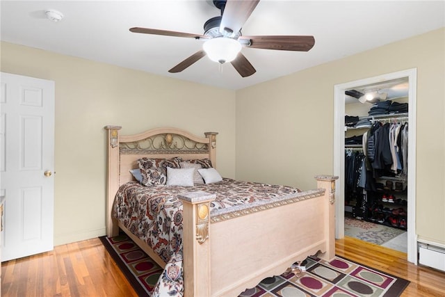 19 S Locust Ave, North Providence, RI 02911 - bedroom with wood finished floors, a spacious closet, a closet, a baseboard heating unit, and ceiling fan