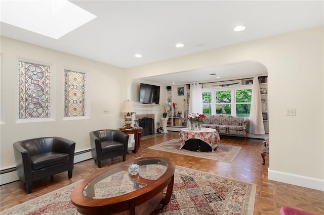 19 S Locust Ave, North Providence, RI 02911 - living room featuring a baseboard heating unit, a fireplace, recessed lighting, baseboards, and a skylight