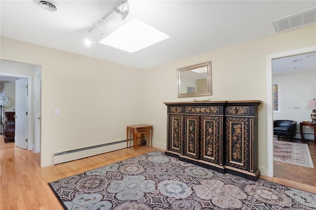 19 S Locust Ave, North Providence, RI 02911 - hall with a baseboard heating unit, a skylight, and light wood-type flooring