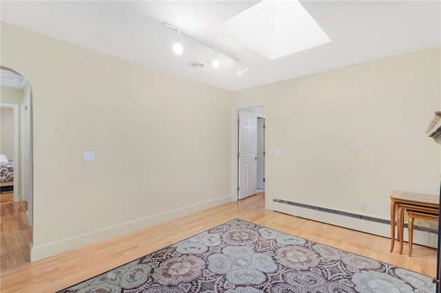 19 S Locust Ave, North Providence, RI 02911 - unfurnished room featuring a skylight, arched walkways, track lighting, light wood-type flooring, and baseboards