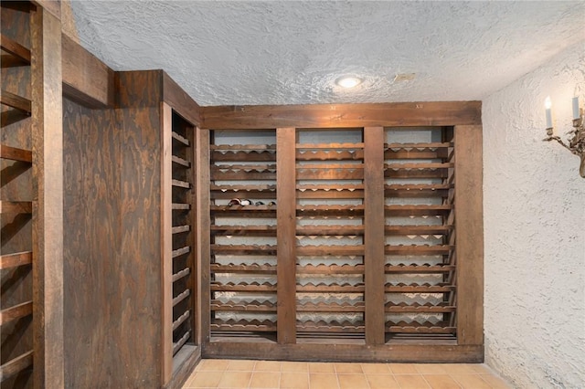 19 S Locust Ave, North Providence, RI 02911 - wine room featuring light tile patterned floors, a textured wall, and a textured ceiling
