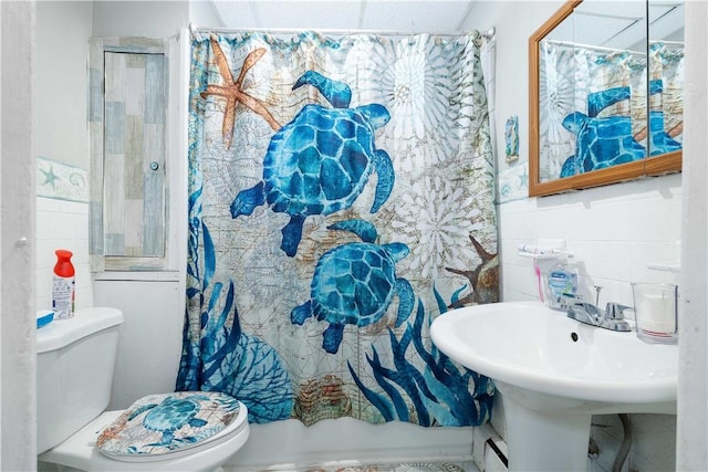 115 Division St, Pawtucket, RI 02860 - bathroom with toilet, a shower with shower curtain, tile walls, and baseboard heating