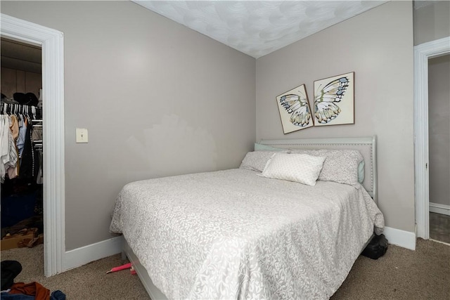 115 Division St, Pawtucket, RI 02860 - bedroom with a walk in closet, a closet, carpet, and baseboards
