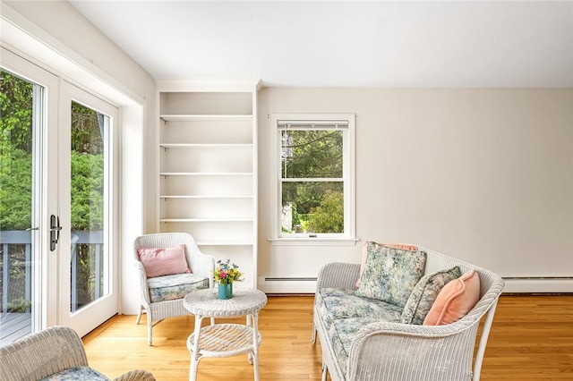 40 Wood Ave, Narragansett, RI 02882 - sitting room featuring a baseboard radiator, light wood-type flooring, and built in features