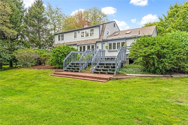 40 Wood Ave, Narragansett, RI 02882 - rear view of house featuring a wooden deck, a chimney, and a yard