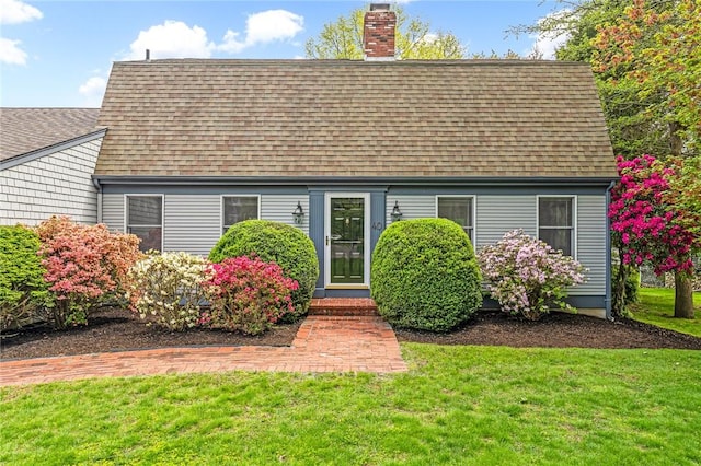 40 Wood Ave, Narragansett, RI 02882 - cape cod house with roof with shingles, a chimney, and a front lawn