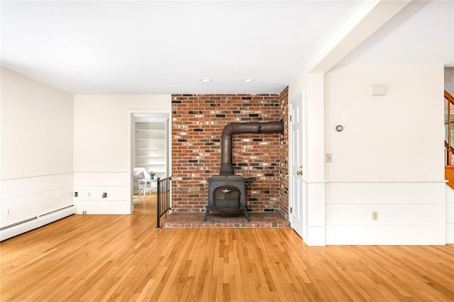 40 Wood Ave, Narragansett, RI 02882 - unfurnished living room with wood finished floors, a wood stove, stairway, baseboard heating, and recessed lighting
