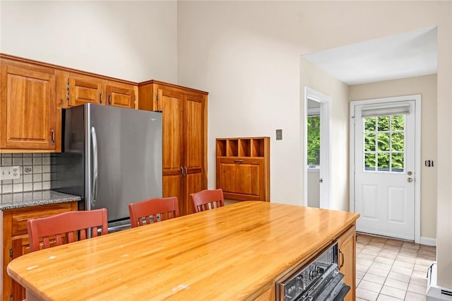 40 Wood Ave, Narragansett, RI 02882 - dining area with light tile patterned floors and a high ceiling