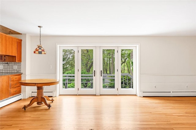 40 Wood Ave, Narragansett, RI 02882 - dining room with a baseboard radiator, healthy amount of natural light, and light wood-style flooring
