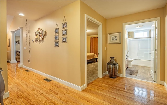 500 Mendon Rd Unit 116, Cumberland, RI 02864 - hallway with light wood-style flooring, decorative columns, and recessed lighting
