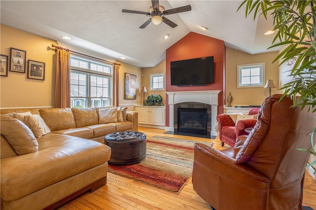 500 Mendon Rd Unit 116, Cumberland, RI 02864 - living area featuring ceiling fan, light wood-style floors, healthy amount of natural light, a fireplace with flush hearth, and lofted ceiling