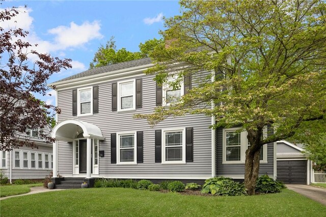 224 Raleigh Ave, Pawtucket, RI 02860 - colonial-style house featuring an outbuilding, a front lawn, and a garage