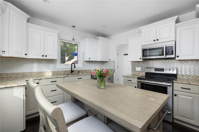 224 Raleigh Ave, Pawtucket, RI 02860 - kitchen with stainless steel appliances, a sink, white cabinets, and tasteful backsplash