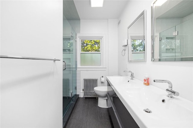 224 Raleigh Ave, Pawtucket, RI 02860 - bathroom featuring radiator heating unit, a shower stall, toilet, and double vanity