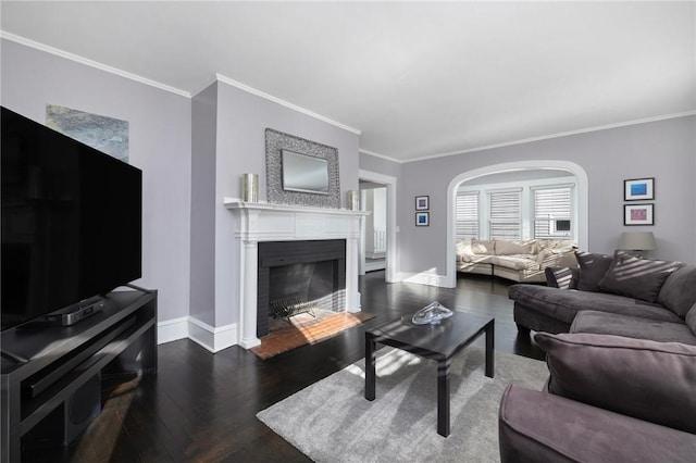224 Raleigh Ave, Pawtucket, RI 02860 - living room featuring ornamental molding, baseboards, a fireplace, wood finished floors, and arched walkways