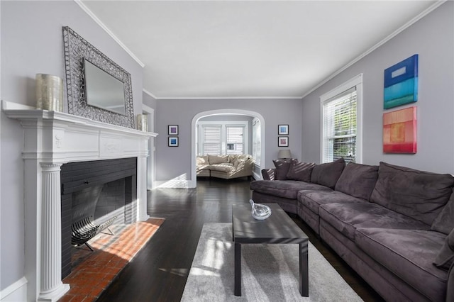 224 Raleigh Ave, Pawtucket, RI 02860 - living area with crown molding, wood finished floors, arched walkways, a fireplace with flush hearth, and baseboards