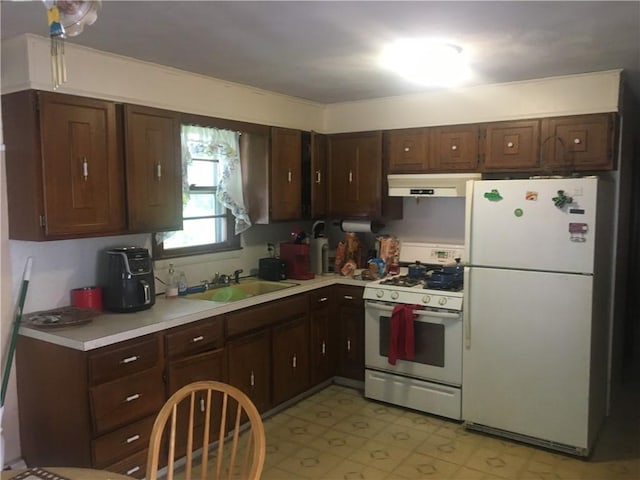 17 Woodcliff Ave, North Providence, RI 02911 - kitchen featuring white appliances, under cabinet range hood, a sink, light floors, and light countertops